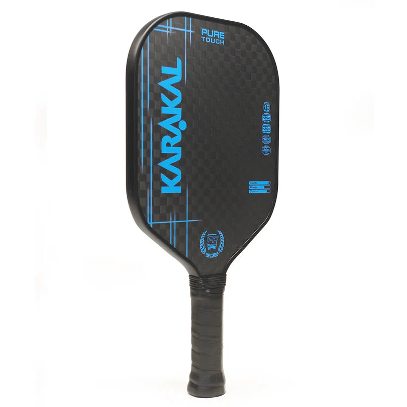 The Karakal Pure Touch Blue Pickleball Paddle by Karakal features blue accents, a textured surface, honeycomb power core, and wrapped handle, shown against a white background.