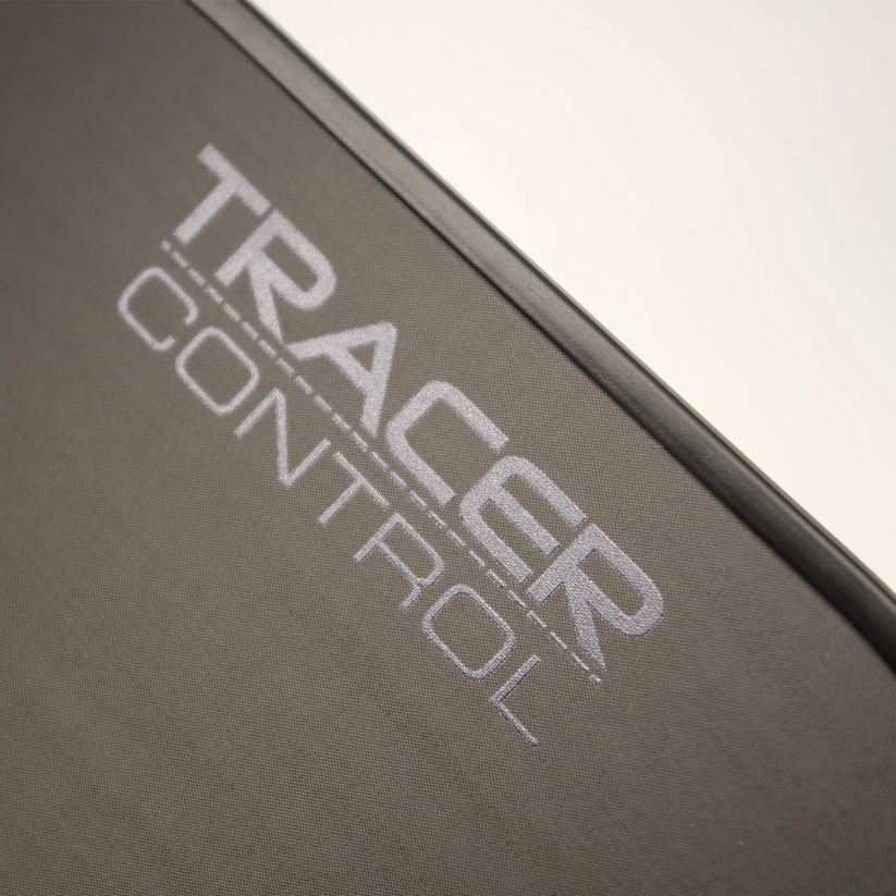 Close-up of the Karakal Tracer Control Pickleball Paddle by Karakal, featuring "TRACER CONTROL" in large, light gray capitals on its black surface, angled diagonally to suggest precise spin control and advanced play.