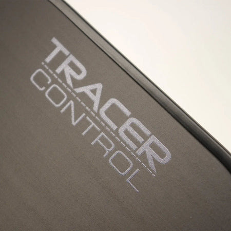 Close-up of the Karakal Tracer Control Pickleball Paddle by Karakal, featuring "TRACER CONTROL" in large, light gray capitals on its black surface, angled diagonally to suggest precise spin control and advanced play.