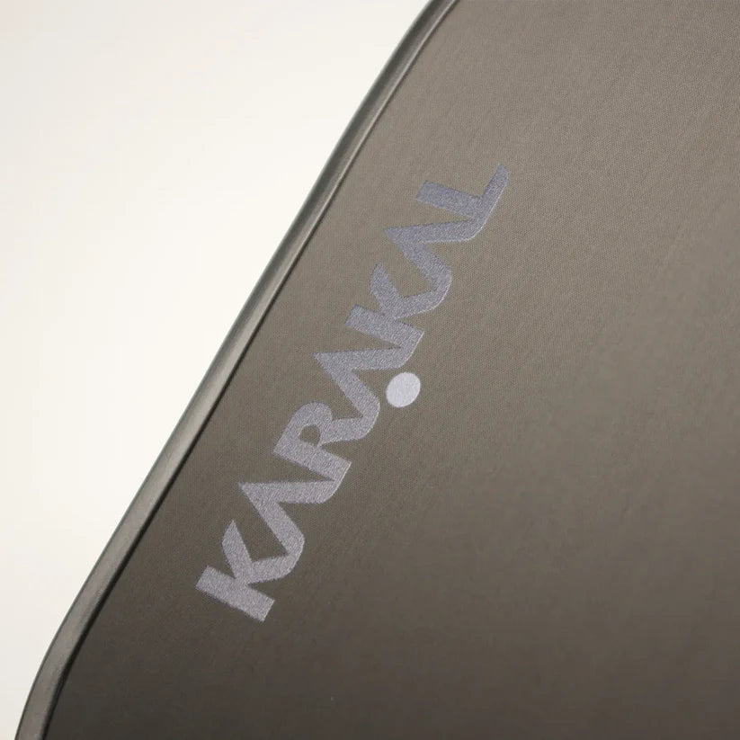 Close-up of the gray Karakal fabric case for the Tracer Control Pickleball Paddle, featuring angled white KARAKAL lettering and emphasizing spin control and precision on the court.