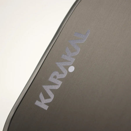 Close-up of the gray Karakal fabric case for the Tracer Control Pickleball Paddle, featuring angled white KARAKAL lettering and emphasizing spin control and precision on the court.