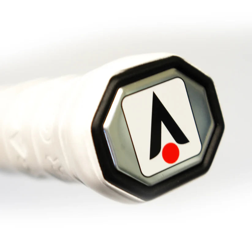 Close-up of a Karakal Air Touch 2.1 Squash Racket handle shows the black and red Karakal logo with an upward arrow and red dot on a white background, highlighting this lightweight racket’s high modulus graphite construction.