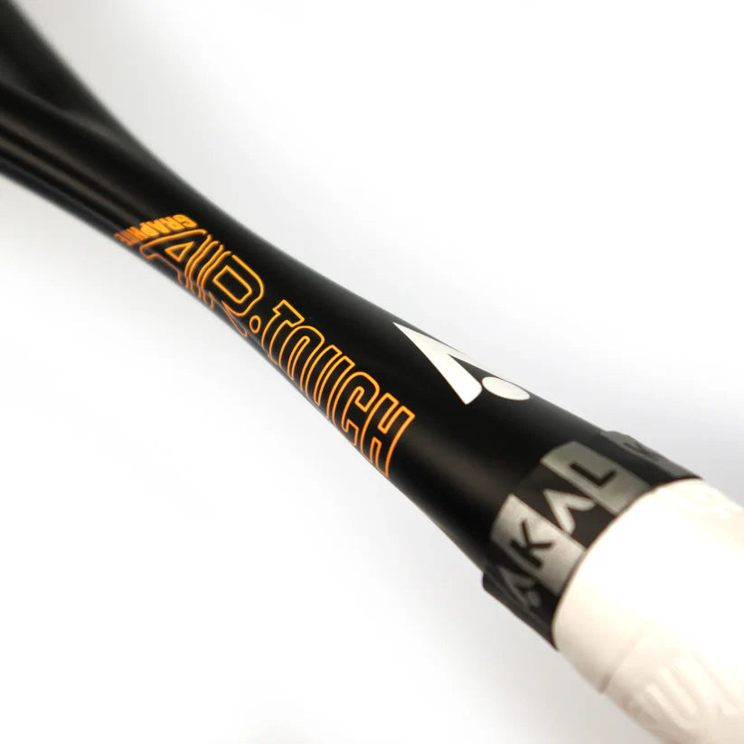 Close-up of the black shaft on the Karakal Air Touch 2.1 Squash Racket, showing AIR.TOUCH in orange and white text and part of the Karakal brand name near the white grip.