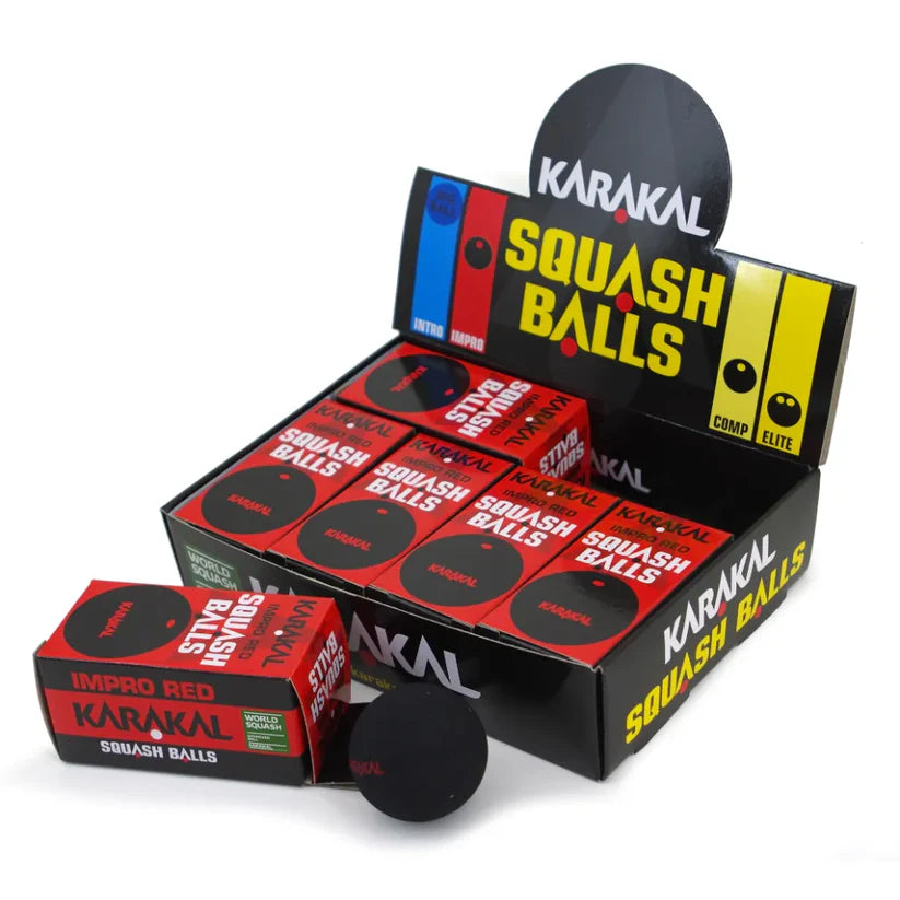 A display box of Karakal Red Dot Squash Balls by Karakal features SQUASH BALLS in bold. In front is one WSF-approved intermediate-level Red Dot ball and a red “IMPRO RED” box, ideal for progressing players.