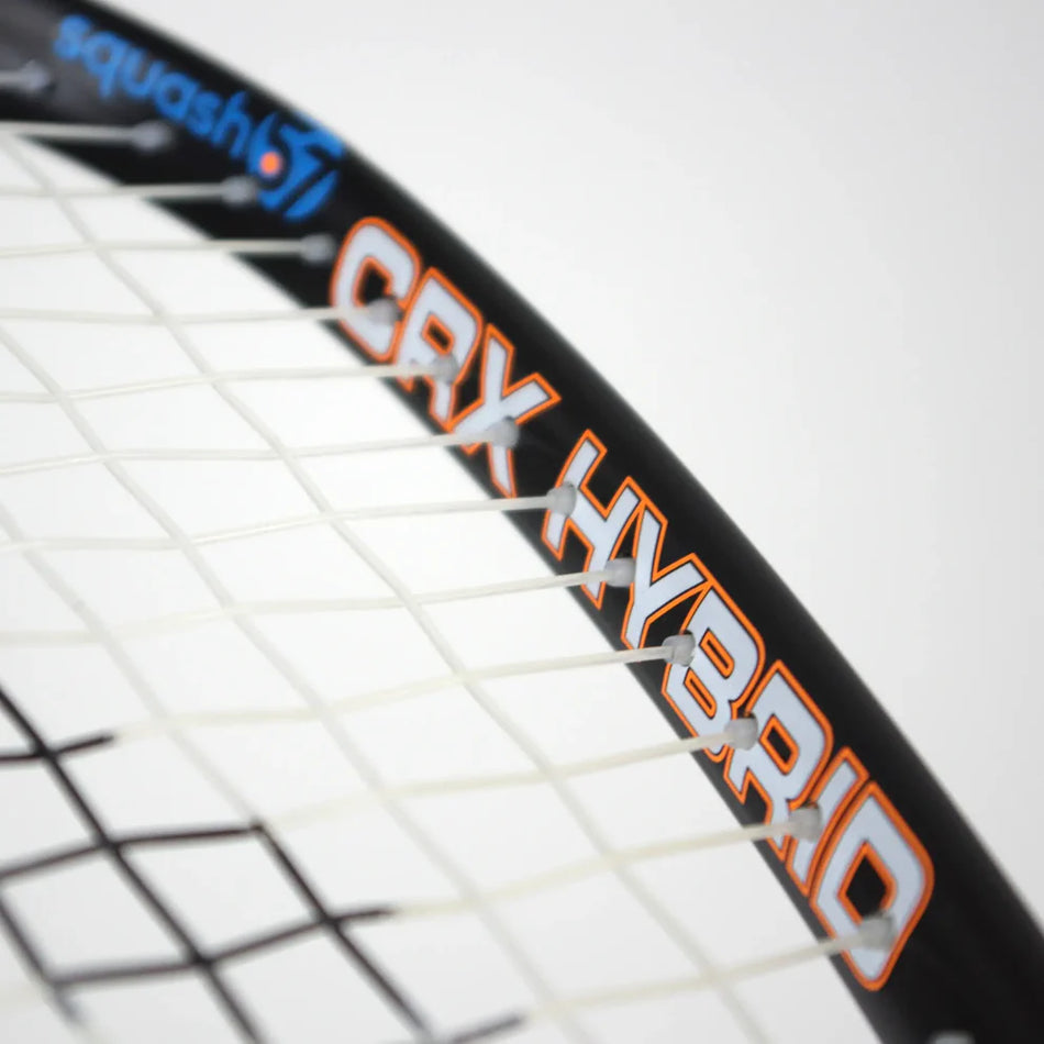 Close-up of the Karakal CRX-Hybrid 2.1 Racketball Racket, a lightweight graphite composite by Karakal featuring white strings, "CRX HYBRID" in orange and white on the midplus frame, and a blue-orange squash logo on the upper part.