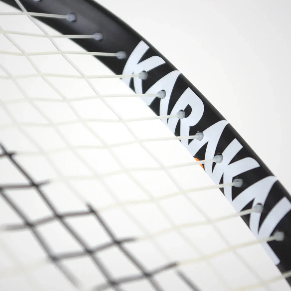Close-up of the Karakal CRX-Hybrid 2.1 Racketball Racket, a lightweight black and white racket with partially visible Karakal branding on the frame and interwoven white strings, set against a plain background.