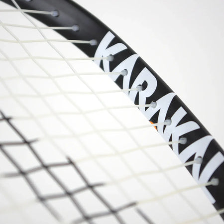 Close-up of the Karakal CRX-Hybrid 2.1 Racketball Racket, a lightweight black and white racket with partially visible Karakal branding on the frame and interwoven white strings, set against a plain background.
