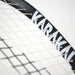 Close-up of the Karakal CRX-Hybrid 2.1 Racketball Racket, a lightweight black and white racket with partially visible Karakal branding on the frame and interwoven white strings, set against a plain background.