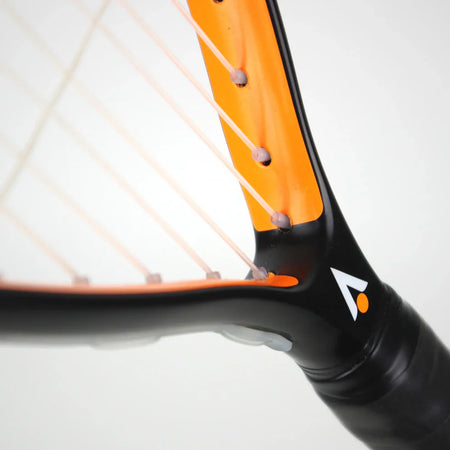 Close-up of the Karakal CRX-Hybrid 2.1 Racketball Racket by Karakal in black and orange graphite composite, with white strings, showing frame detail and part of the logo against a plain light background.