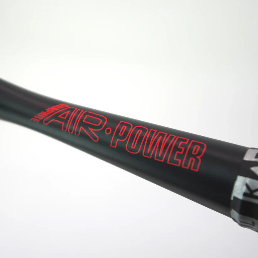 Close-up of a black cylindrical object with bold red "AIR POWER" lettering, likely part of the Karakal Air Power 2.1 Squash Racket by Karakal, crafted from high modulus graphite for superior performance.
