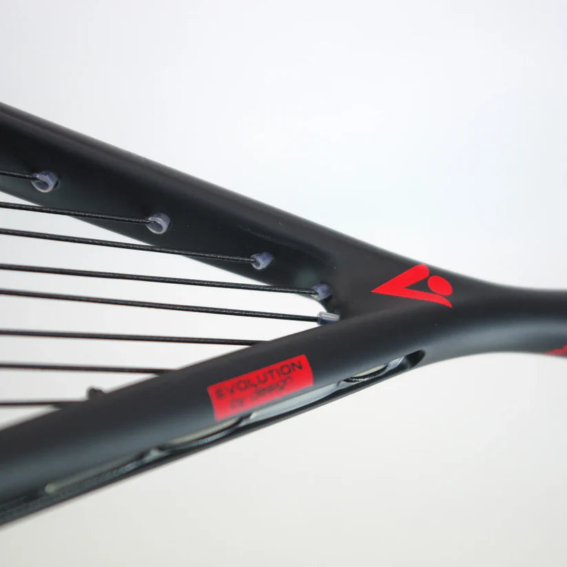 Close-up of the Karakal Air Power 2.1 Squash Racket by Karakal, showing its black high modulus graphite frame with red accents, black strings, visible string holes, and a red label against a plain light background.