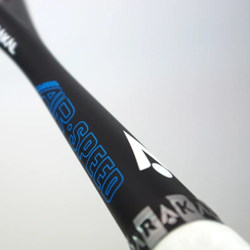 Close-up of the Karakal Air Speed 2.1 Squash Racket by Karakal, made with high modulus graphite and labeled "AIR SPEED" in blue, featuring a white logo and gray-white handle markings against a light background.