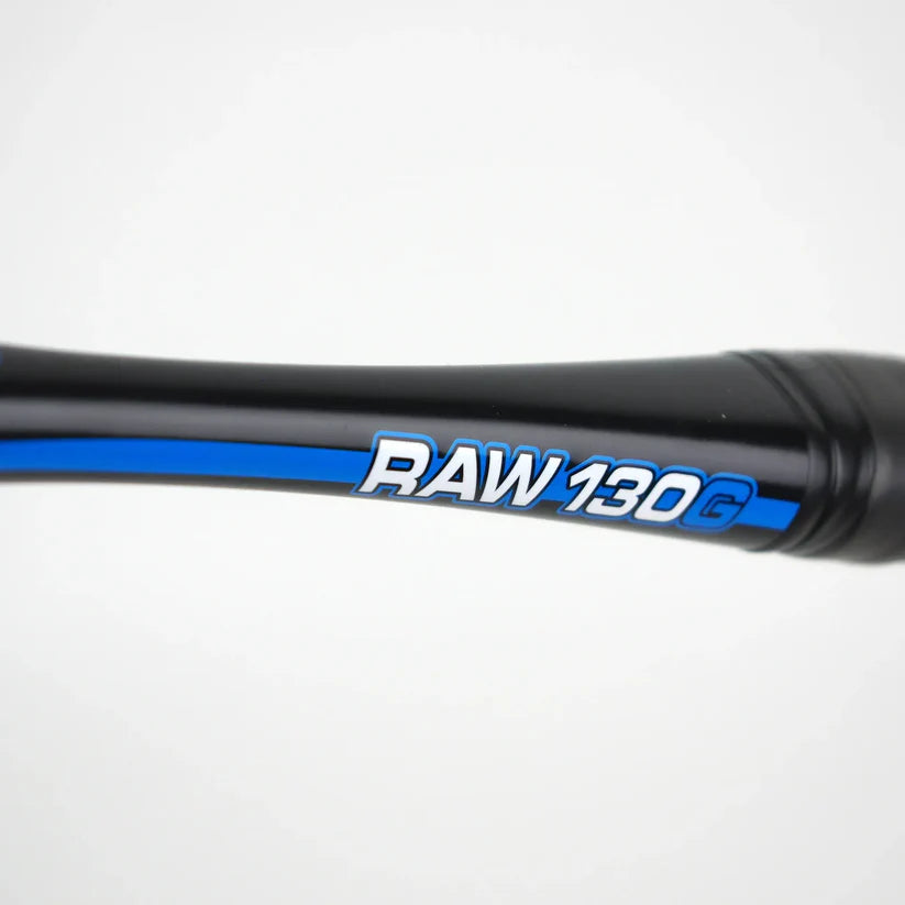 Close-up of the Karakal Raw 130 2.1 Squash Racket shaft featuring a blue stripe and “RAW 130G” in white and blue. The graphite frame from Karakal stands out against a plain, light-colored background.