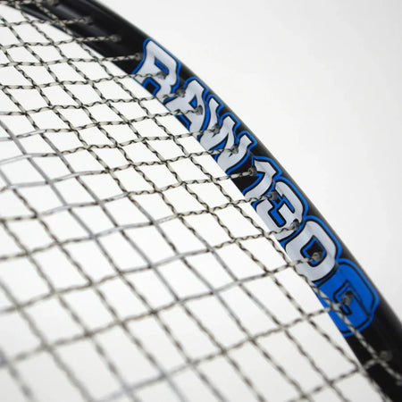 Close-up of a Karakal Raw 130 2.1 Squash Racket featuring a graphite frame, tightly woven strings, and bold white and blue "RAW 130G" lettering on the frame, set against a plain white background.