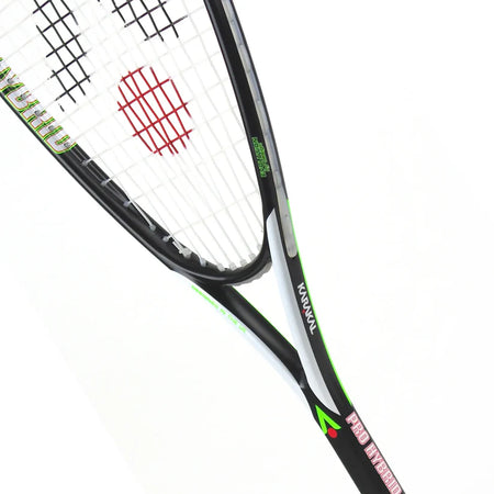A close-up of the Karakal Pro Hybrid 2.1 Squash Racket by Karakal, featuring black and green accents, white strings, and a red circular logo on the string bed, set against a plain white background.