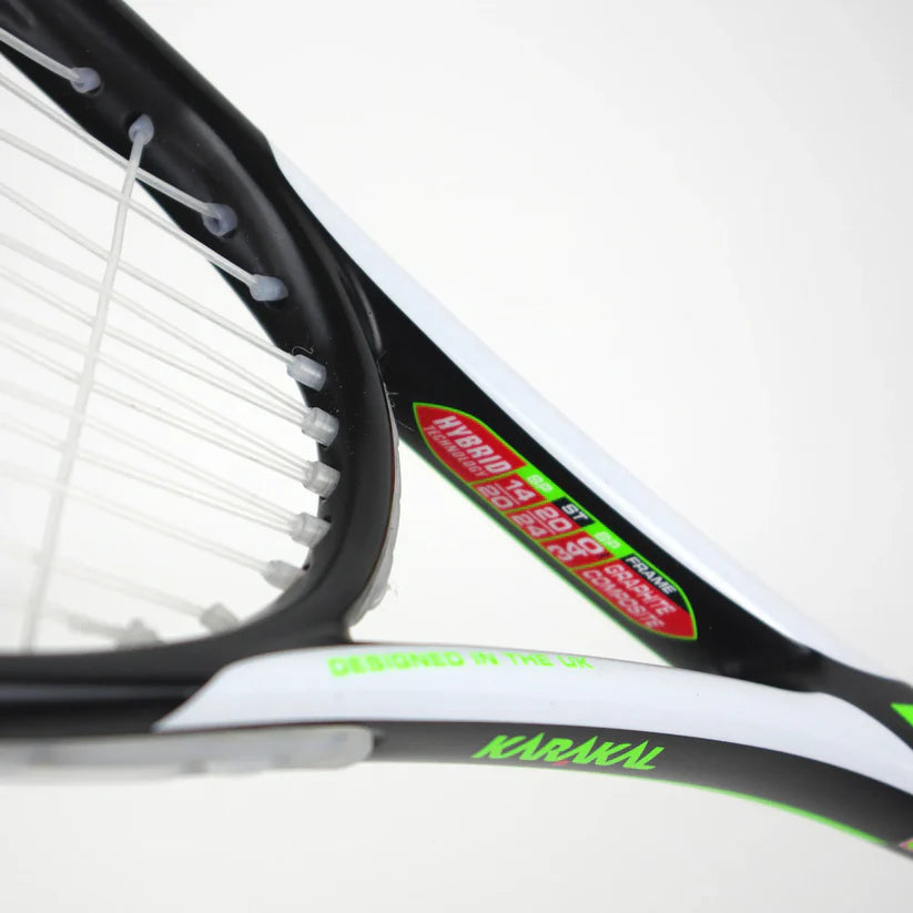 Close-up of a Karakal Pro Hybrid 2.1 Squash Racket in black, white, and green, featuring visible strings, the KARAKAL logo, and “DESIGNED IN THE UK” stickers that showcase this lightweight racket’s premium quality.