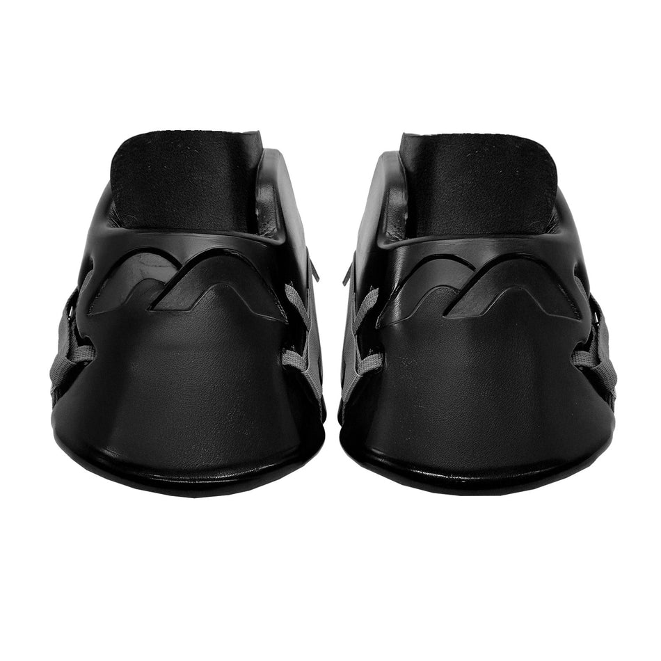 The Mercian Genesis 2 Kickers by Mercian are black slip-on shoes with rounded toes and a wavy raised upper design, crafted from high-density foam for a custom fit and enhanced comfort. Shown from the front on a plain white background.