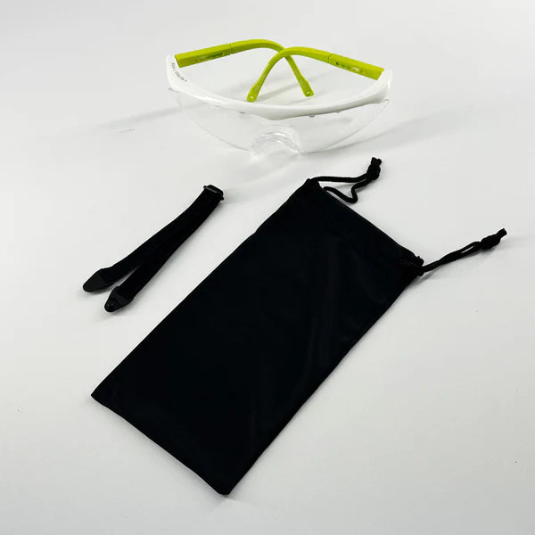 The Karakal Pro 2500 Sports Eye Protection for ladies/juniors by Karakal features clear goggles with green arms, a detachable black strap, and a black pouch—ideal junior eye guards for squash protection.