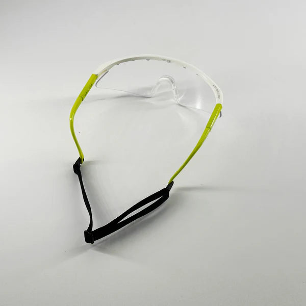 The Karakal Pro 2500 Sports Eye Protection (Ladies/Juniors) by Karakal features clear lenses, lime green arms, a white frame, and a black adjustable strap—ideal for junior eye guards or squash protection, shown on a plain white background.