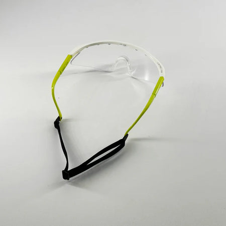 The Karakal Pro 2500 Sports Eye Protection (Ladies/Juniors) by Karakal features clear lenses, lime green arms, a white frame, and a black adjustable strap—ideal for junior eye guards or squash protection, shown on a plain white background.