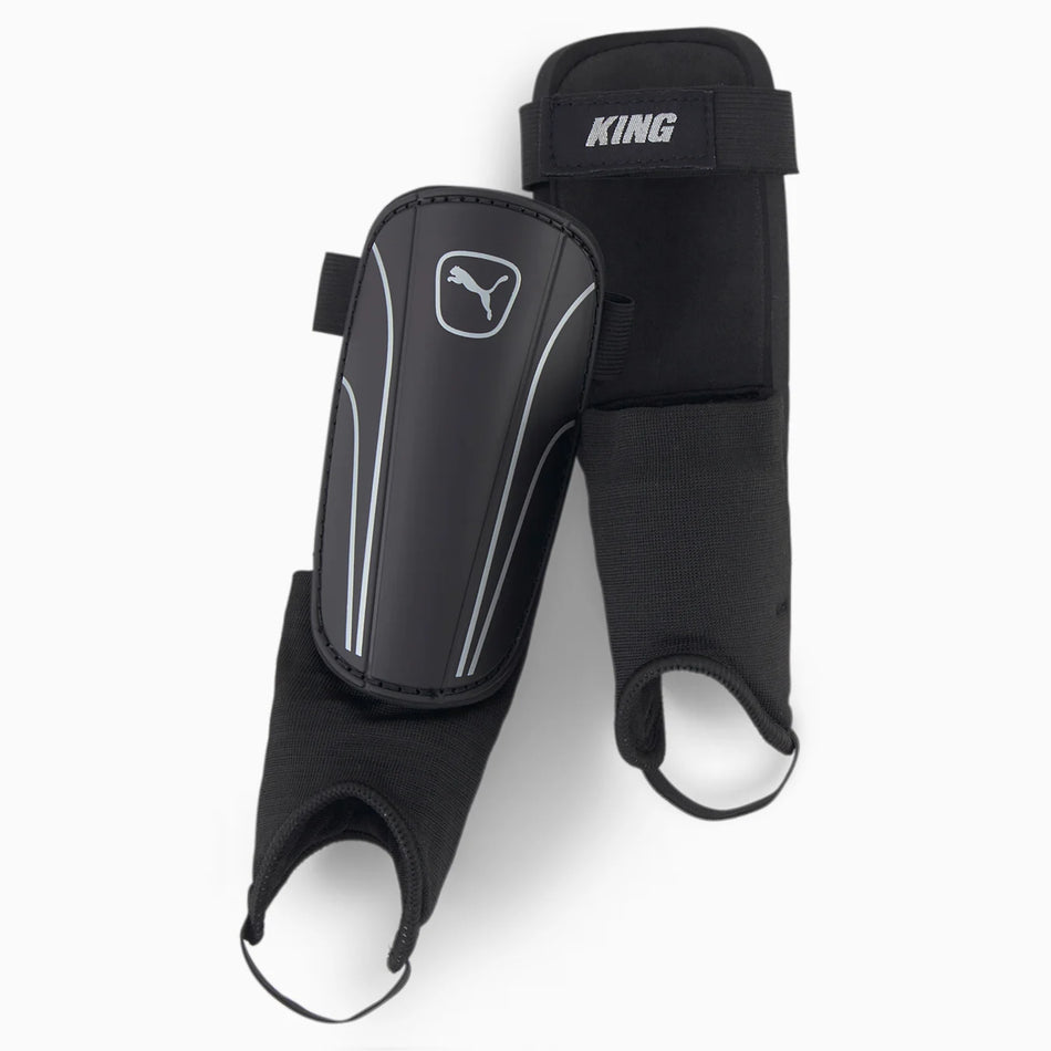 Puma King Shin & Ankle Guards by Puma offer black football protection with shock-absorbing ankle support, elastic straps for a secure fit, and feature the Puma logo on each guard.