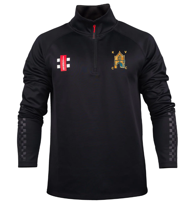 The Gray Nicolls Kingswood Village CC Pro Thermo Fleece is a black long-sleeve athletic pullover featuring a red 1/4 zip, multicolored club crest left chest, red rectangular logo right chest, and checkered detail on lower sleeves.