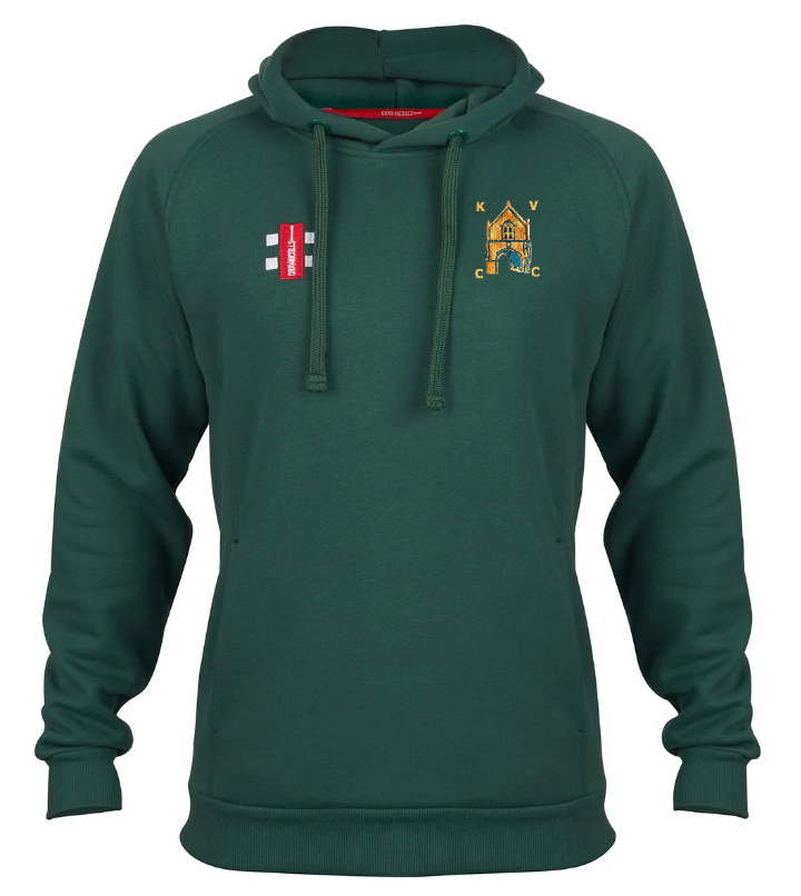 The Gray Nicolls Kingswood Village CC Velocity Hoodie is dark green with drawstrings, a red rectangular patch on the right chest, a yellow embroidered KVC crest on the left, and made from sustainable cotton for active comfort.