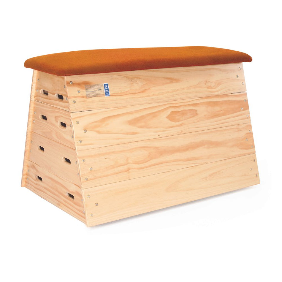 The Niels Larsen Activvault Box is a natural-colored, wooden junior vault box with a slanted design, multiple side handles, and an orange padded top for safe and comfortable gymnastics.