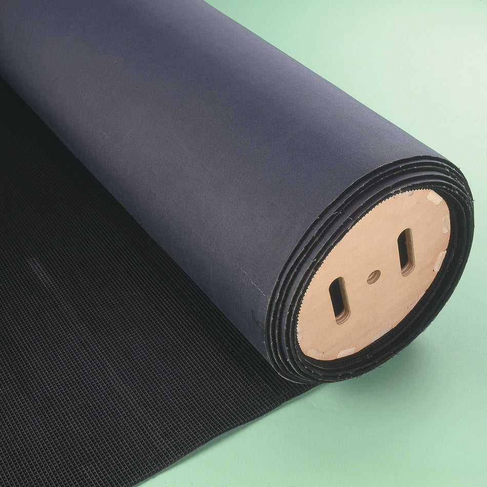 The Niels Larsen Matting Creel, a large black textured matting roll with a wooden core, is partially unrolled on a light green surface—ideal for efficient gymnastics mat storage.