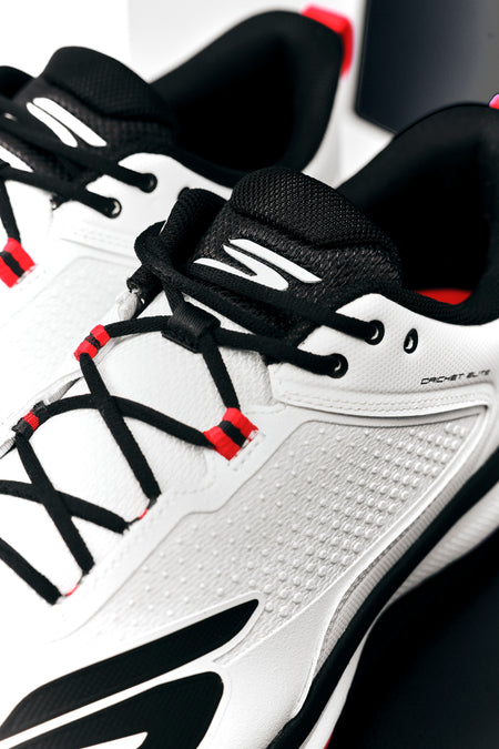 Close-up of Skechers Cricket Elite Cricket Shoe, white with black laces, black and red accents, and textured side panels. Designed by Skechers for superior grip on the field.