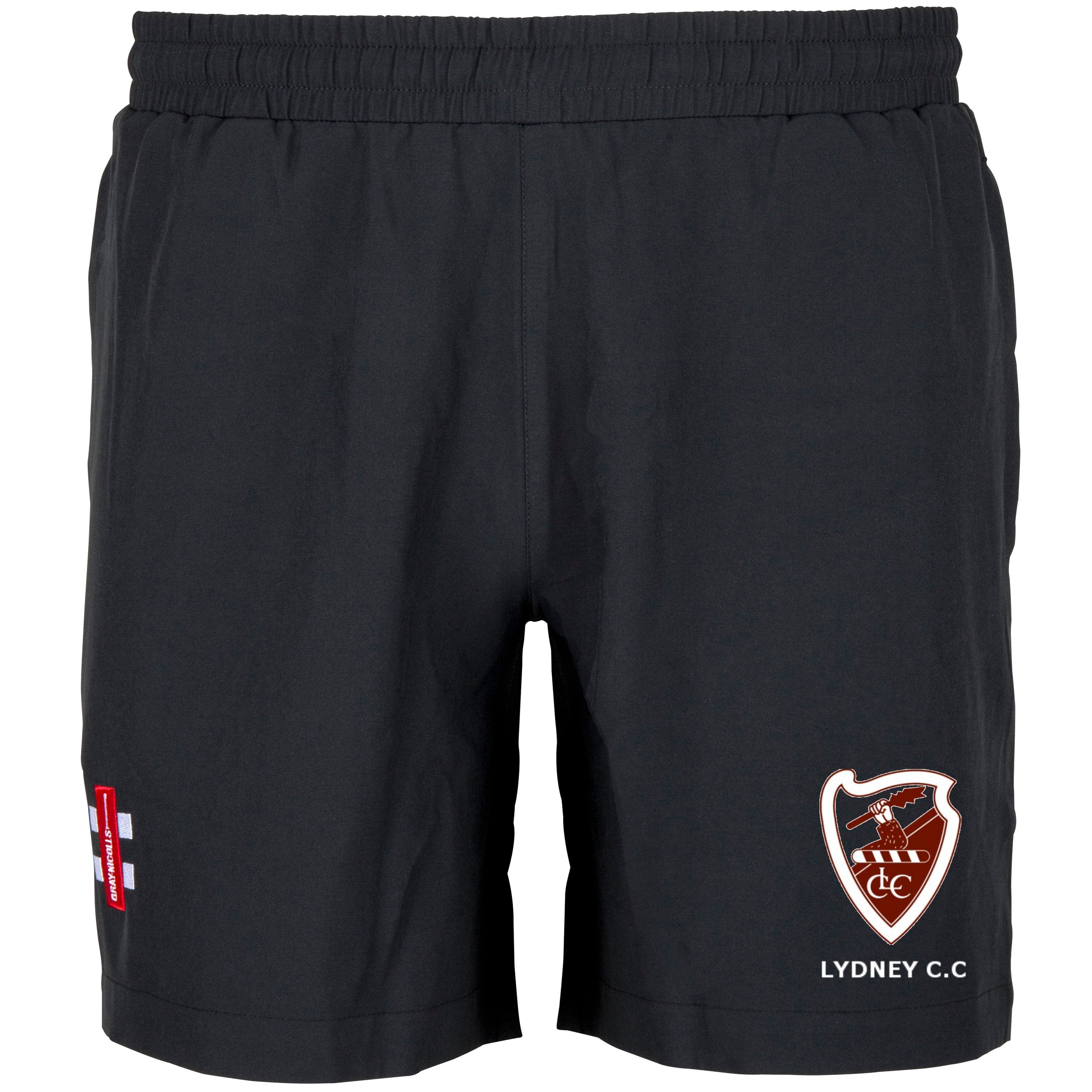 The Gray Nicolls Lydney CC Velocity Shorts are lightweight black training shorts with an embroidered red and white Lydney C.C. crest on the right leg and a small cross logo on the left, ideal for cricket practice.
