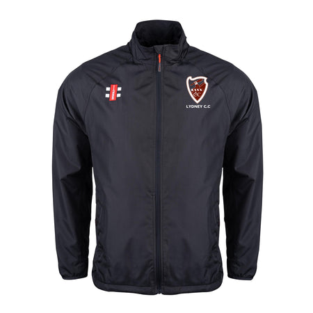 The Gray Nicolls Lydney CC Velocity Rain Jacket is a black, lightweight, water repellent cricket jacket with a stand-up collar, zip front, and two embroidered chest logos: the Lydney C.C. shield and red/black/white vertical emblem.