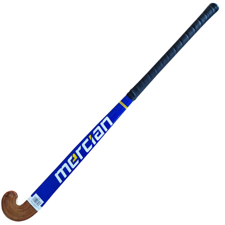 The Mercian Maestro Hockey Stick is a blue wooden field hockey stick with a black grip, cotton tape wrap, curved end, and white/yellow Mercian logo—ideal for beginners.