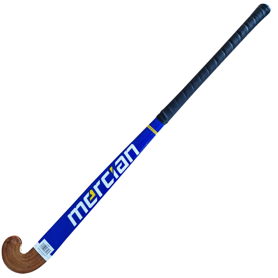 The Mercian Maestro Hockey Stick is a blue wooden field hockey stick with a black grip, cotton tape wrap, curved end, and white/yellow Mercian logo—ideal for beginners.