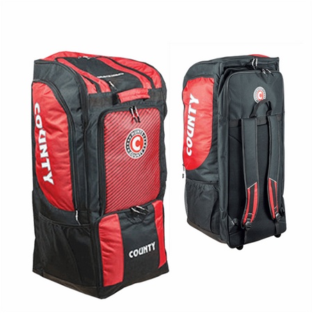 Two Hunts County Maximo Large Wheeled Duffle Bags in black and red are shown—one displays zippered compartments, the other shows its shoulder straps. Both feature "COUNTY" branding.