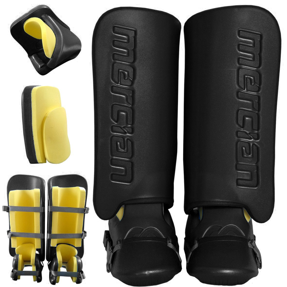 The Mercian Genesis 0.3 GK Set features black field hockey shin guards with yellow high-density foam padding, shown from front, side, and back angles. The Mercian logo is embossed on the front—ideal protection for young goalkeepers.