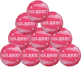 A pyramid stack of ten pink Gilbert Pulse Netballs by Gilbert, each with white swirl patterns and bold branding, ideal for club netball or training, displayed against a plain background.