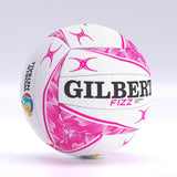 The Gilbert Fizz Match Netball by Gilbert is shown on a light background, featuring white and pink colors, the World Netball logo, FIZZ branding, pink star patterns, and a performance butyl bladder.