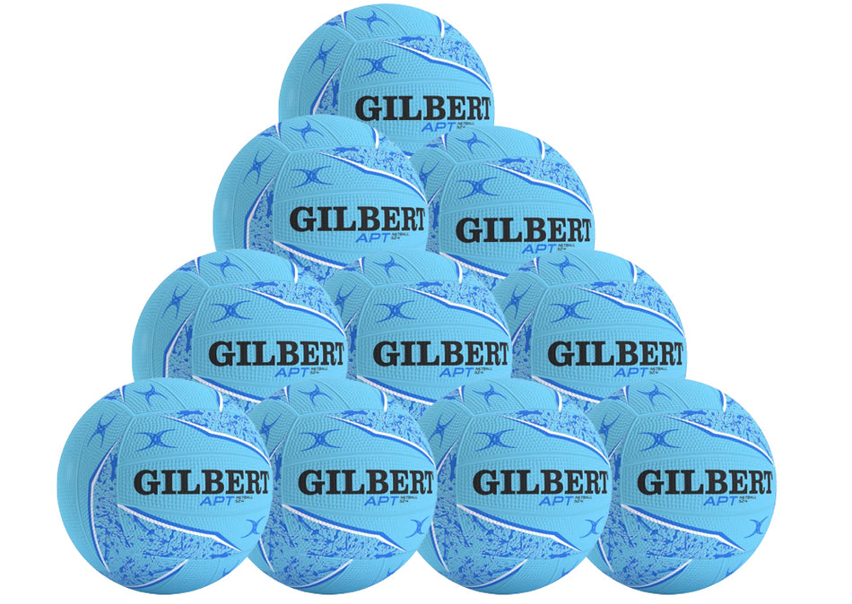 The Gilbert APT 2026 Netball Ten Ball Pack includes ten light blue training netballs with black and dark blue patterns, each boldly displaying the Gilbert brand name—ideal for outdoor practice.