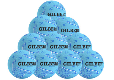 The Gilbert APT 2026 Netball Ten Ball Pack includes ten light blue training netballs with black and dark blue patterns, each boldly displaying the Gilbert brand name—ideal for outdoor practice.