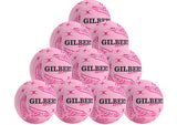 A pyramid stack of ten pink Gilbert APT 2026 netballs with black text and patterns, displayed on a white background. From Gilbert, this netball pack is ideal for team or school outdoor training.