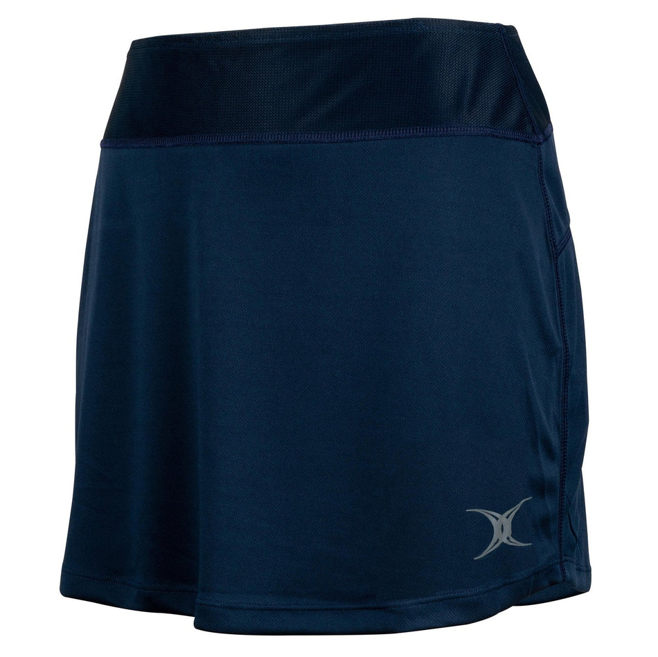 The Gilbert Atom Skort by Gilbert features a classic navy blue design with a wide waistband and a subtle silver logo near the left hem. Crafted from smooth polyester fabric, this women’s sports skort offers superior moisture management for lasting comfort, all while maintaining a simple, sporty style.