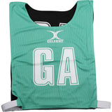 A green/black Gilbert Reversible Netball Bib featuring large GA letters and the Gilbert brand—ideal for team bibs at your next game.