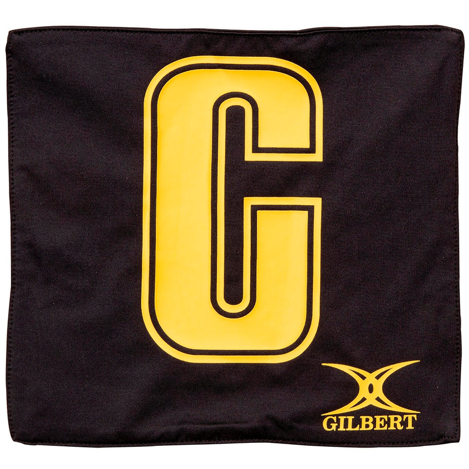 The Gilbert Pro Patch Bibs in black feature a large yellow "C" at the center and a yellow Gilbert logo at the bottom right, making them ideal for team player identification during netball training.