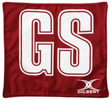 The Gilbert Pro Patch Bibs by Gilbert feature a red square cloth with large white "GS" letters outlined in red, plus the GILBERT logo—ideal for team player identification at netball training.