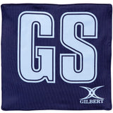Navy blue Gilbert Pro Patch Bibs feature large white GS letters with black outline for clear player ID during netball training. Includes the Gilbert brand logo and name in white at the bottom right.