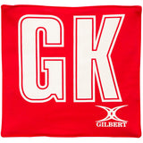 The Gilbert Pro Patch Bibs in red feature large white GK letters for easy player ID during netball training, with the Gilbert logo in white at the bottom right.