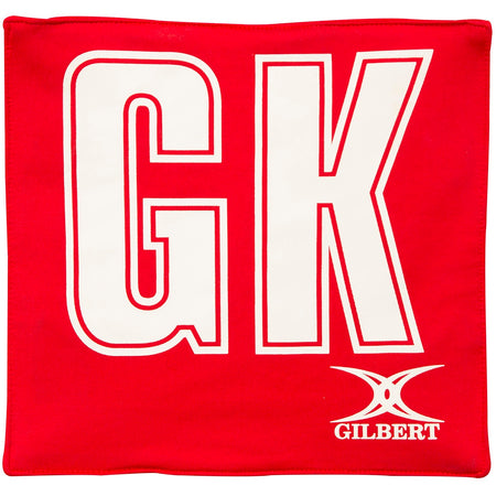 The Gilbert Pro Patch Bibs in red feature large white GK letters for easy player ID during netball training, with the Gilbert logo in white at the bottom right.
