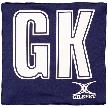 The Gilbert Pro Patch Bibs by Gilbert are navy blue with large white GK letters centered for team player identification in matches or training. The GILBERT logo appears at the bottom right.