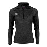 The Gilbert Atom Midlayer is a black women’s training top with long sleeves, a quarter-zip front, and a small white Gilbert logo on the left chest, shown on an invisible mannequin against a white background. Lightweight for comfort and performance.